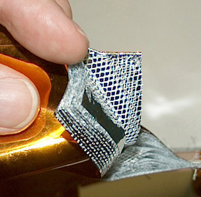 Close-up of a fanned-out stack of single insulation layers.